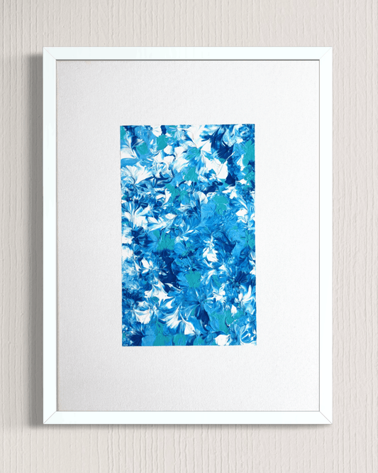 A framed abstract art print featuring a vibrant blue and white floral pattern, presented in a white frame with a white mat against a light gray textured wall.