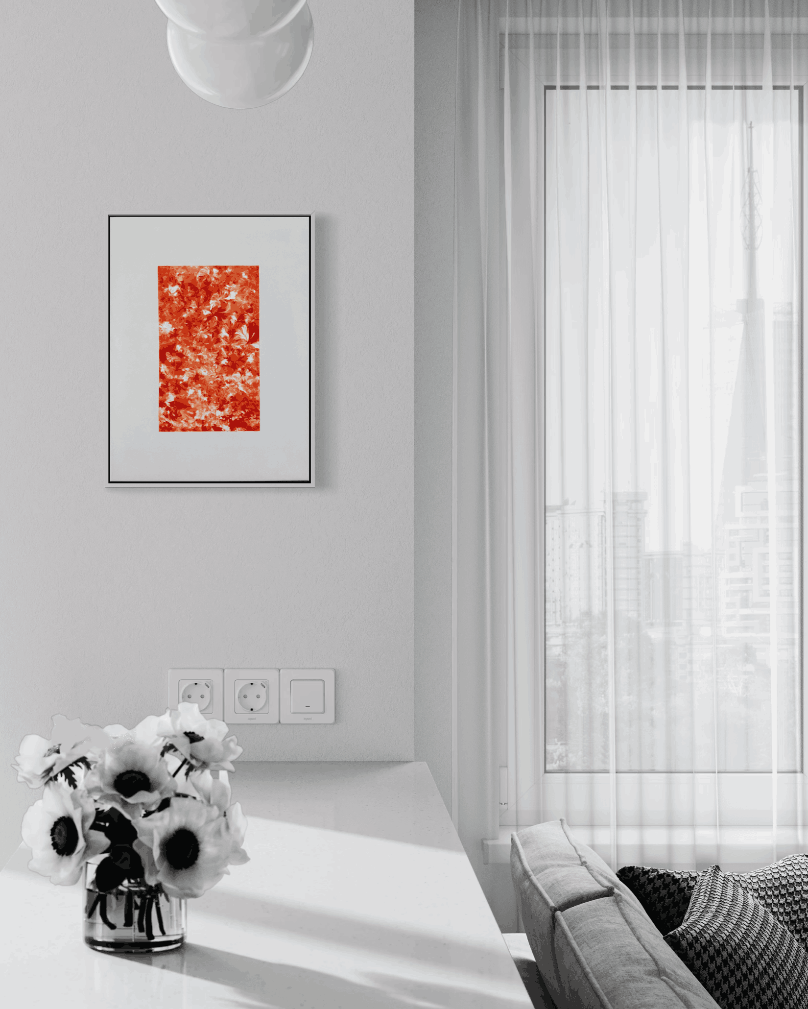 A framed abstract art print with a vibrant red and orange textured design, displayed on a light gray wall in a modern, minimalist living room setting.