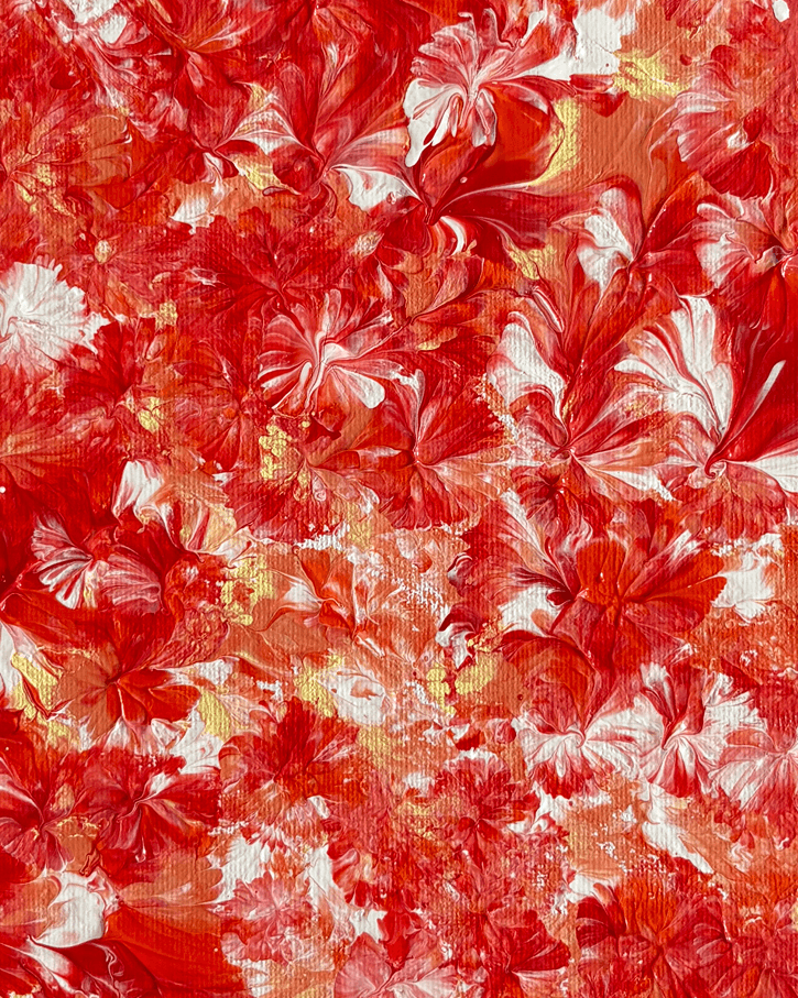 A close-up of a red and white marbled or floral-like pattern with orange and small gold flecks throughout, filling the entire frame.
