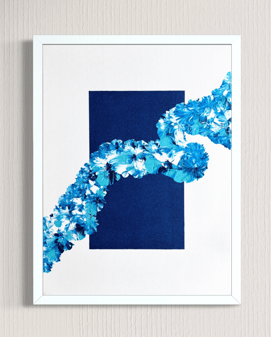 Framed abstract wall art featuring a dark navy blue rectangle with a diagonal blue and white floral or textured ribbon-like shape across it, shown against a light wall.
