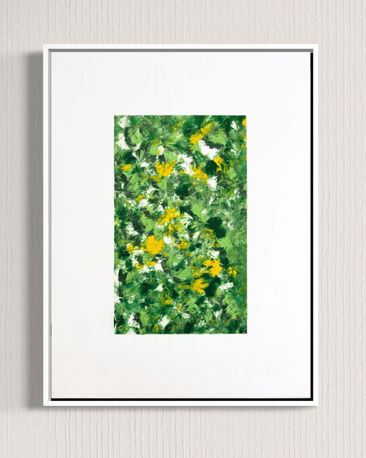 A framed botanical art print featuring an impressionistic green and yellow flower pattern, presented in a white frame with a wide white mat against a light gray textured wall.