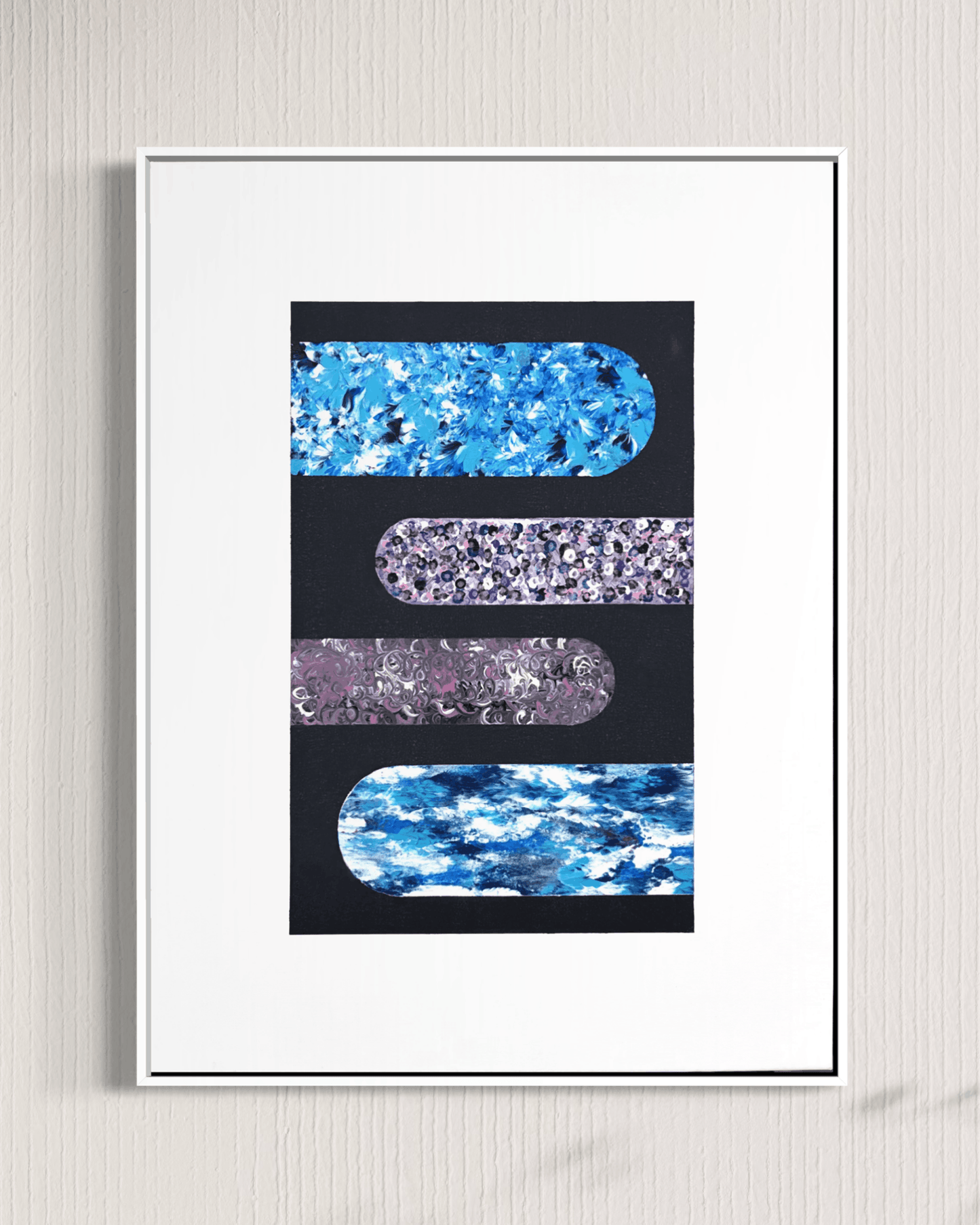 A framed abstract art print featuring four horizontal rounded rectangular bands of blue, purple, and marbled textures on a black background, set within a white mat and thin black frame against a light textured wall.