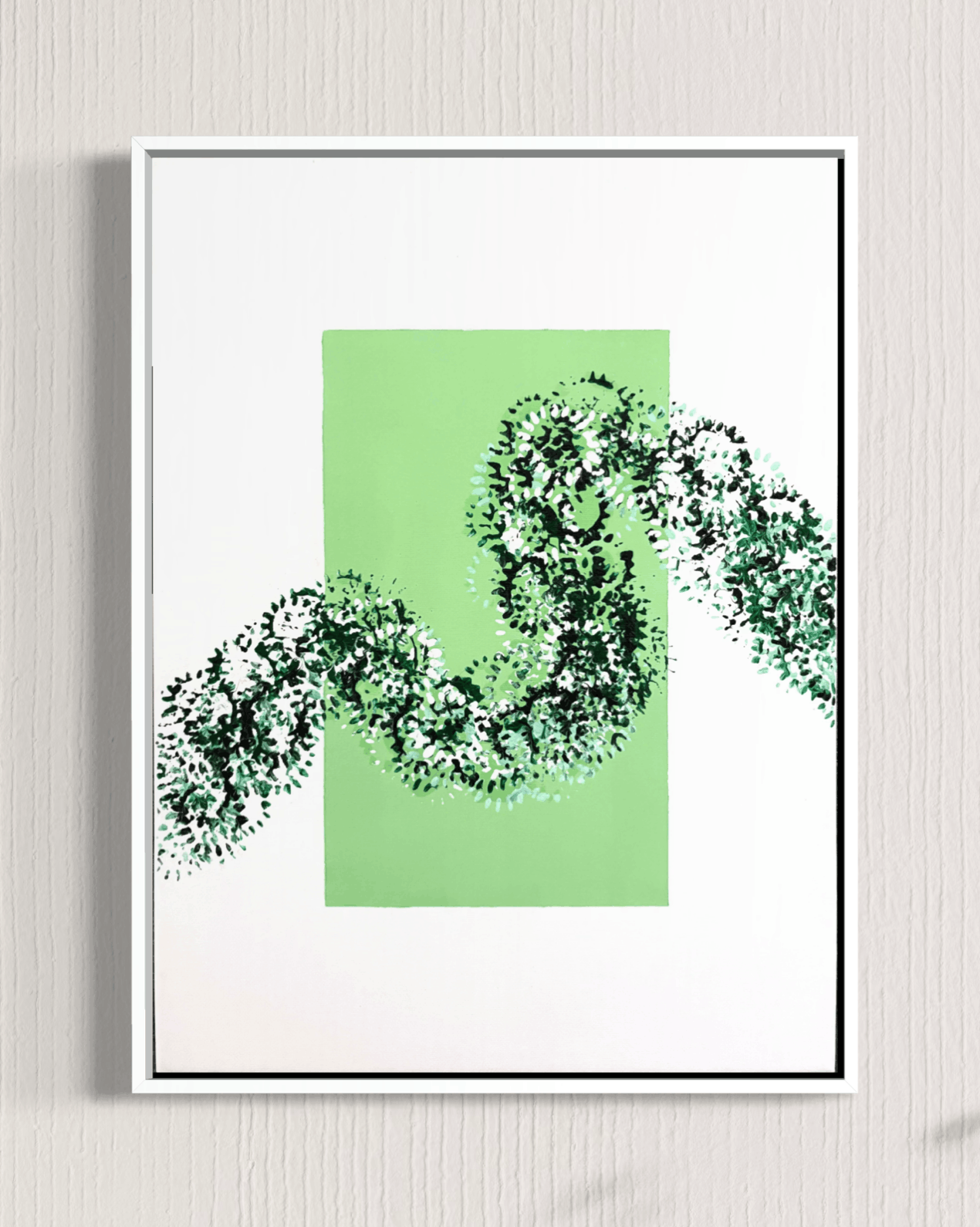 A framed abstract art print featuring a light green rectangular block with a dark green and white textured snake-like pattern crossing it, displayed on a light gray textured wall.