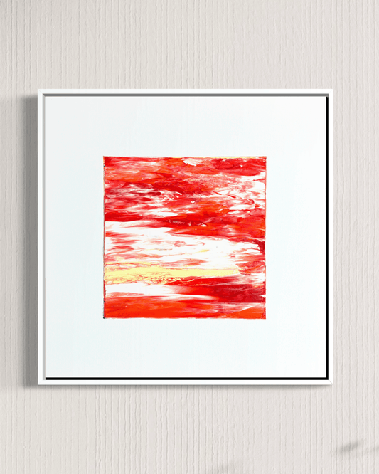 Framed abstract wall art featuring a vibrant red and orange textured painting with white and yellow brushstrokes, set in a white frame against a light gray textured wall.